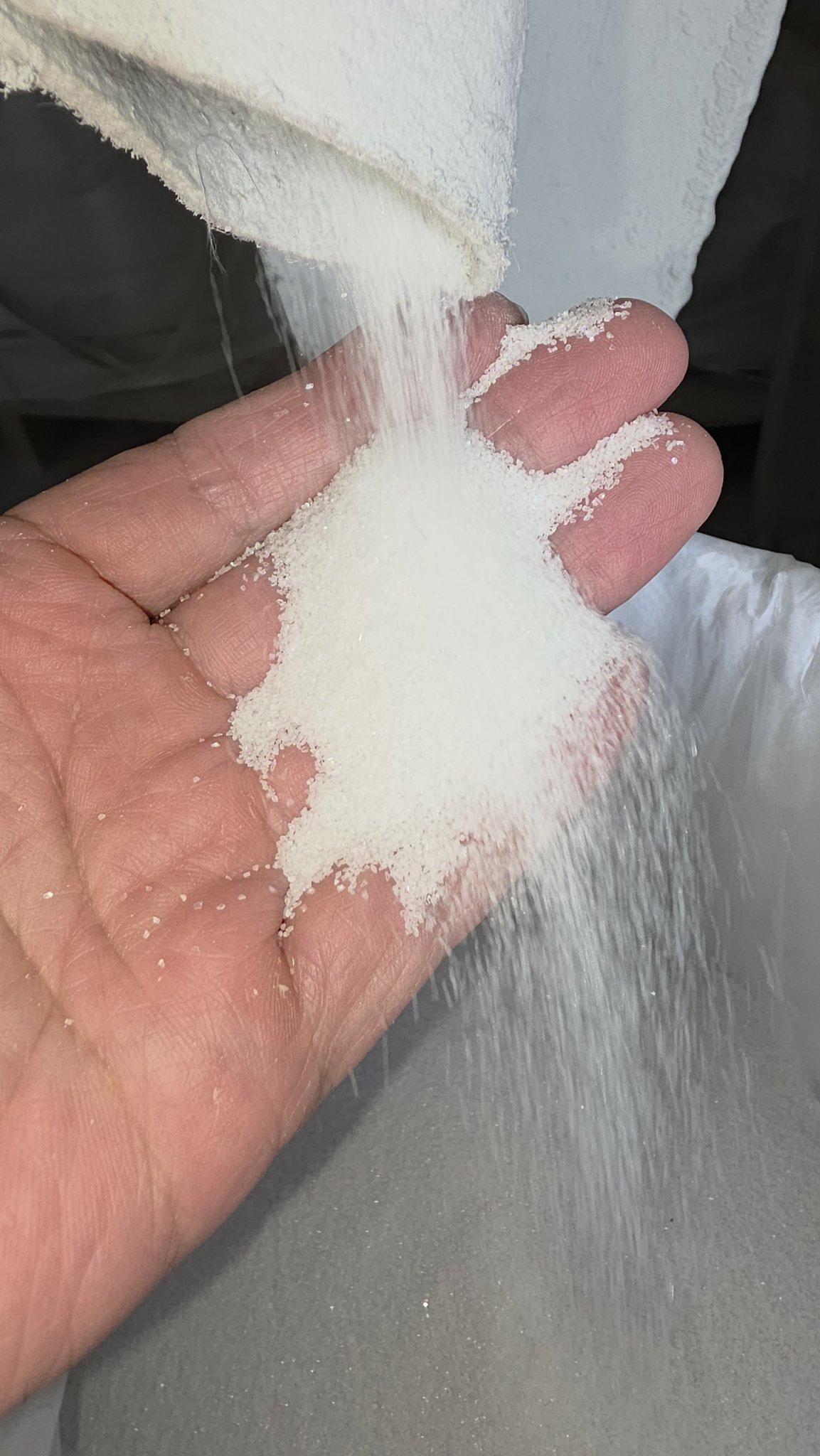 Medium white fused alumina F grit held in hand