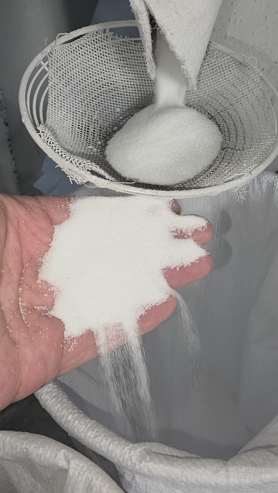 White fused alumina fine powder on a fine test sieve mesh